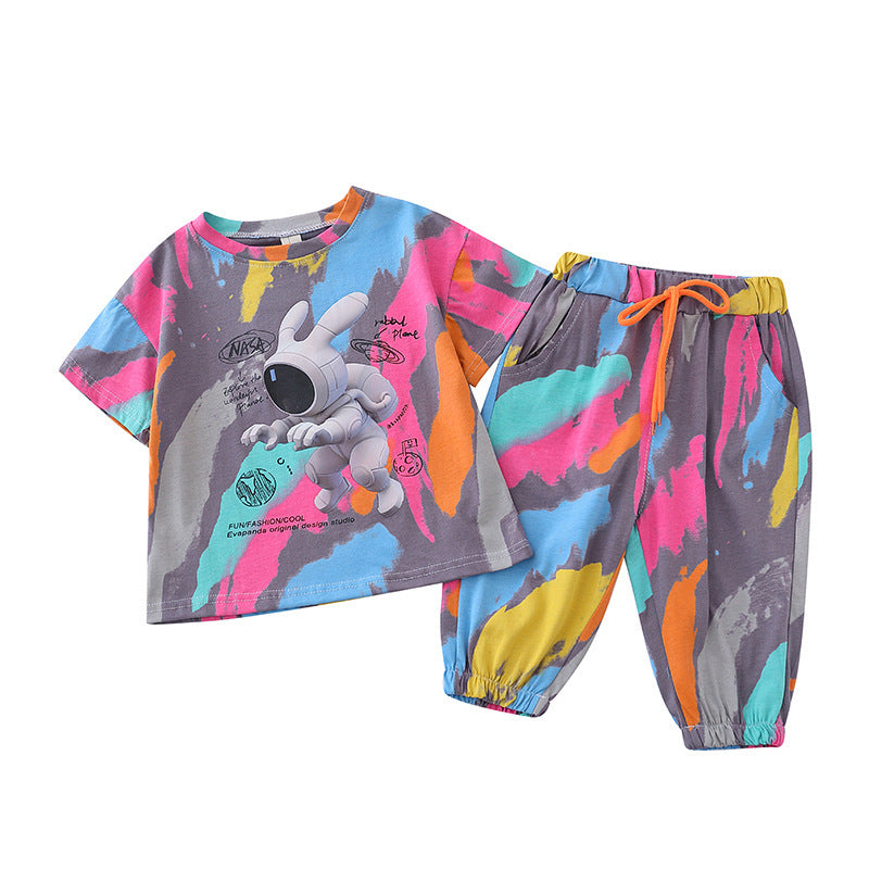 Children's summer suit set, with a colorful t-shirt featuring a cartoon character and matching pants, displayed on hangers.