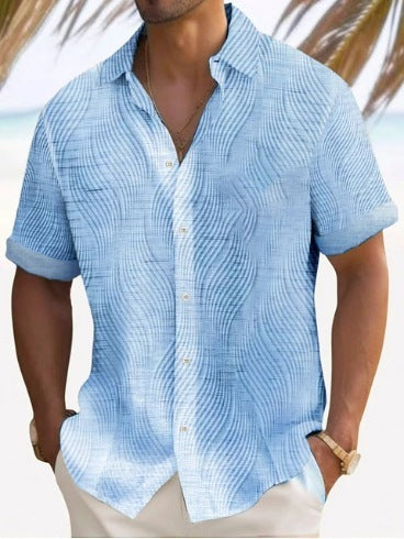 A man wearing a short-sleeved, striped beach shirt in white and blue colors
