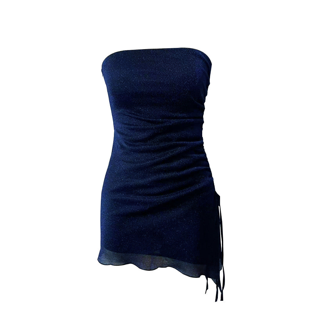 A tube top dress with a drawstring design, backless, made of gold and silver silk, and available in dark blue and champagne colors. The dress is shown in two angles, one showcasing the front and the other highlighting the back.
