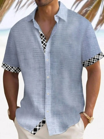 A man wearing a short-sleeved, striped beach shirt in white and blue colors