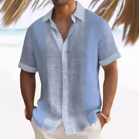 A man wearing a short-sleeved, striped beach shirt in white and blue colors