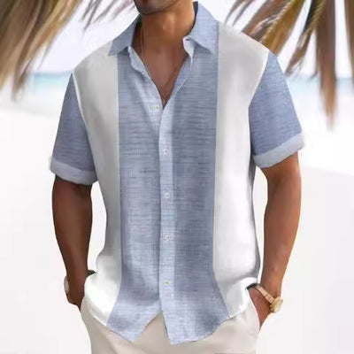 A man wearing a short-sleeved, striped beach shirt in white and blue colors