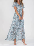A model wearing a floral print, short sleeve, V-neck, A-line, maxi dress in blue, with additional color options shown on the side.