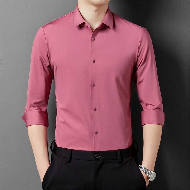 A person in a dark pink long-sleeved shirt rolling up the sleeves, showcasing the shirt's fit and material.