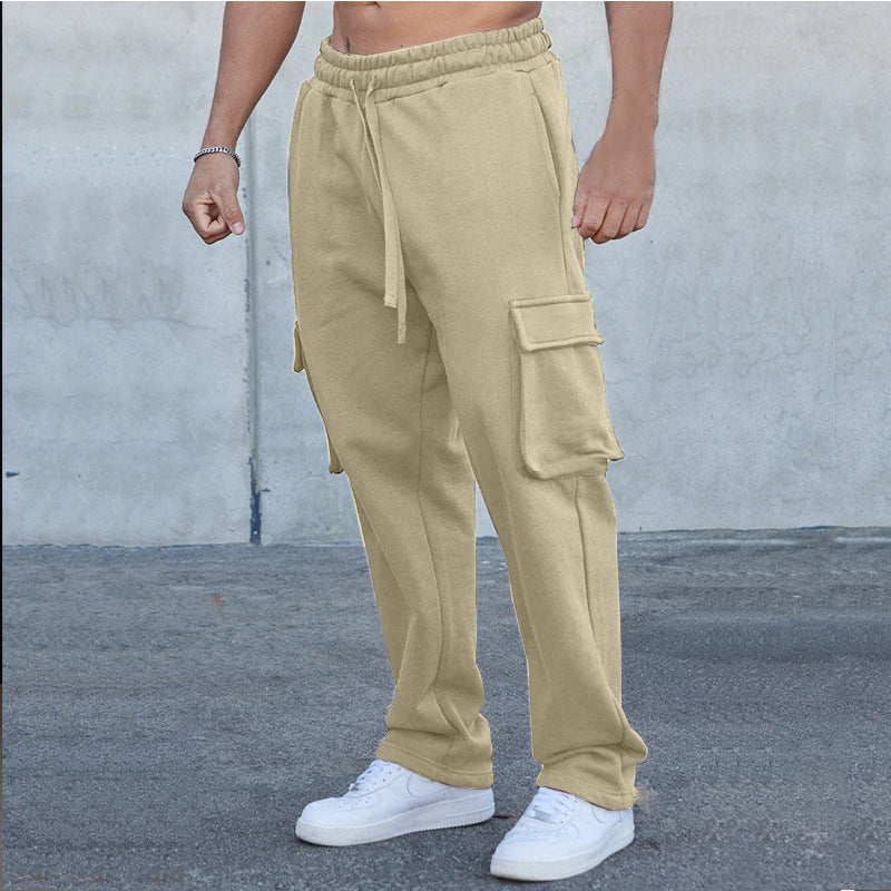 A pair of men's straight-leg trousers with multi-pocket design and drawstring waist in a black color.