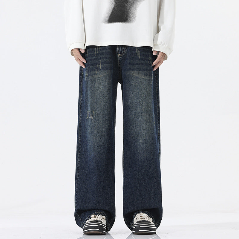 A pair of men's straight-leg jeans in a vintage blue and black gray color.