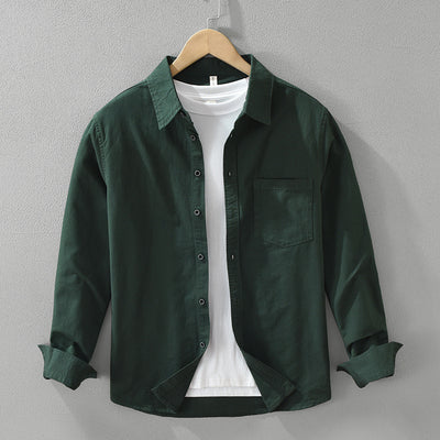 A long sleeve men's shirt in dark green color, displayed on a wooden hanger with a white inner shirt visible.