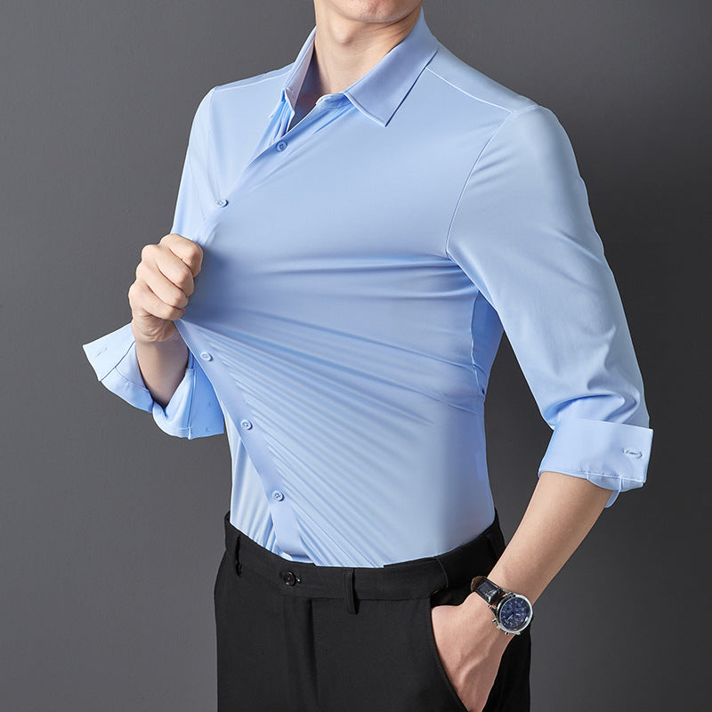 A person in a sky blue long-sleeved shirt rolling up the sleeves, showcasing the shirt's fit and material.