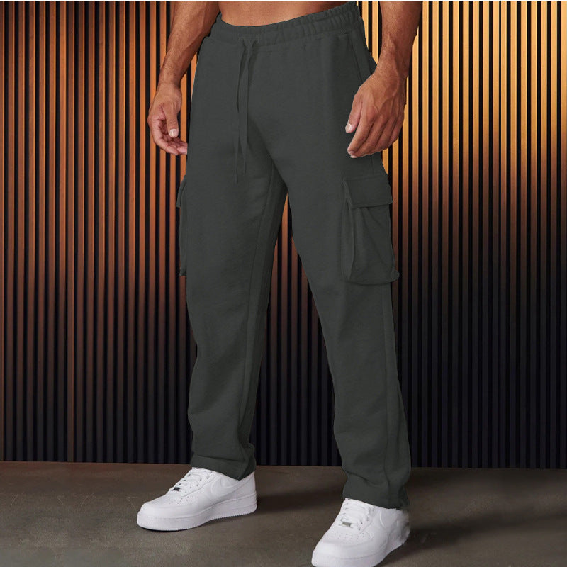 A pair of men's straight-leg trousers with multi-pocket design and drawstring waist in a black color.