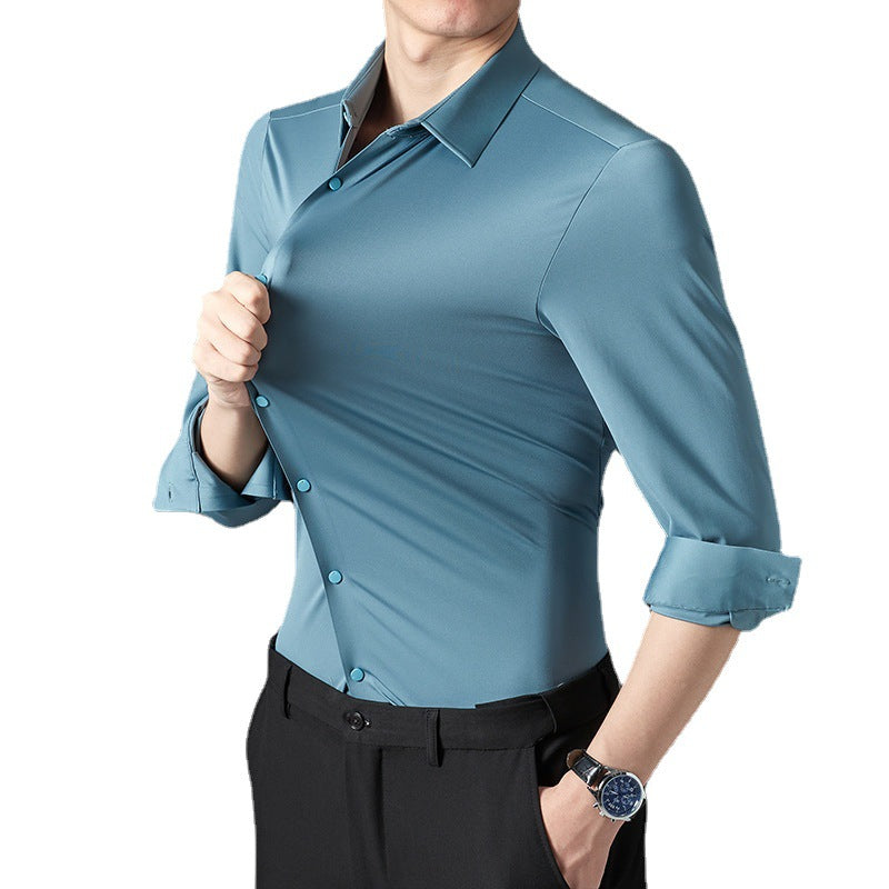 A person in a blue long-sleeved shirt rolling up the sleeves, showcasing the shirt's fit and material.