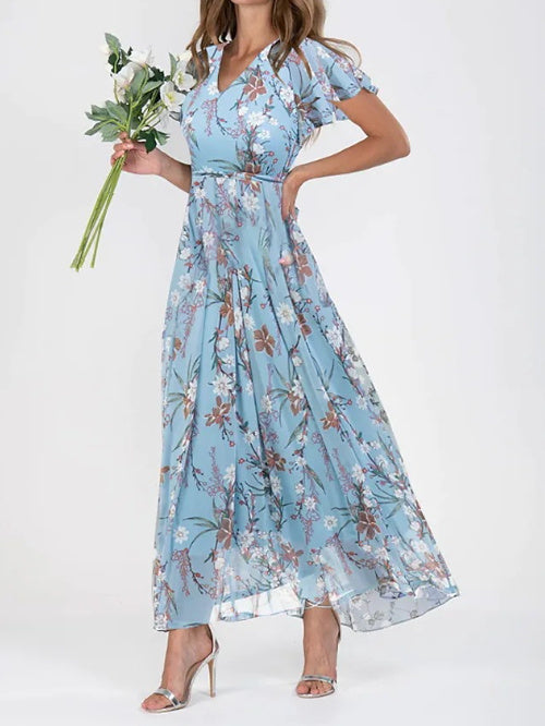 A model wearing a floral print, short sleeve, V-neck, A-line, maxi dress in blue, with additional color options shown on the side.