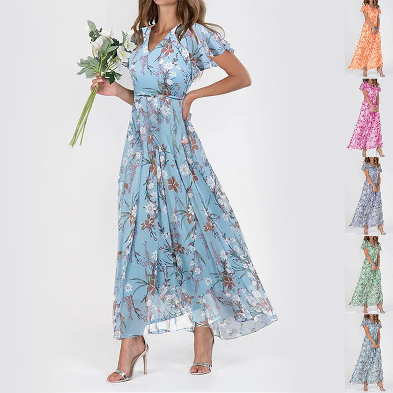 A model wearing a floral print, short sleeve, V-neck, A-line, maxi dress in blue, with additional color options shown on the side.