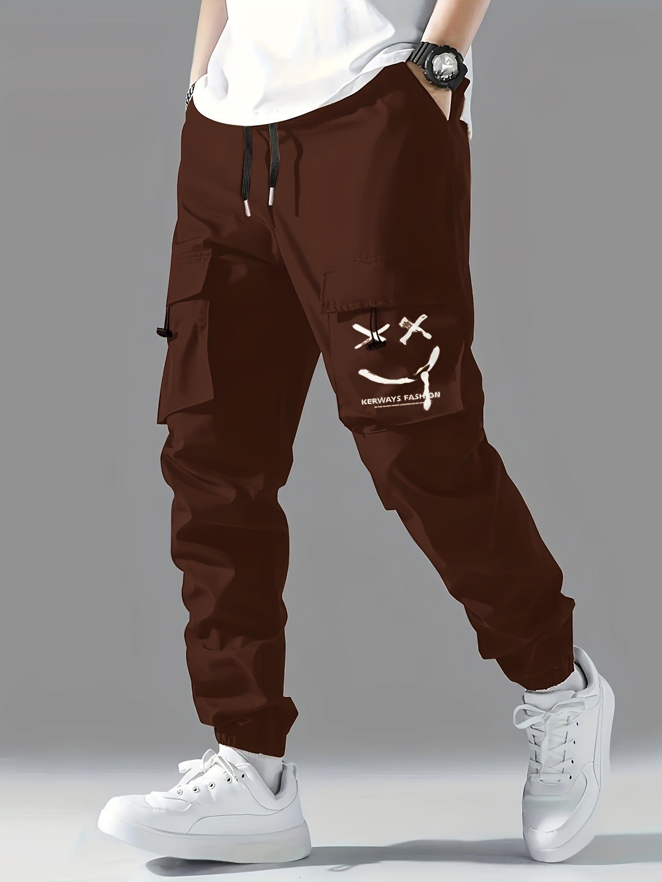 A person wearing black straight-leg ankle-tied overalls casual pants with a mid-waist waist and white sneakers.