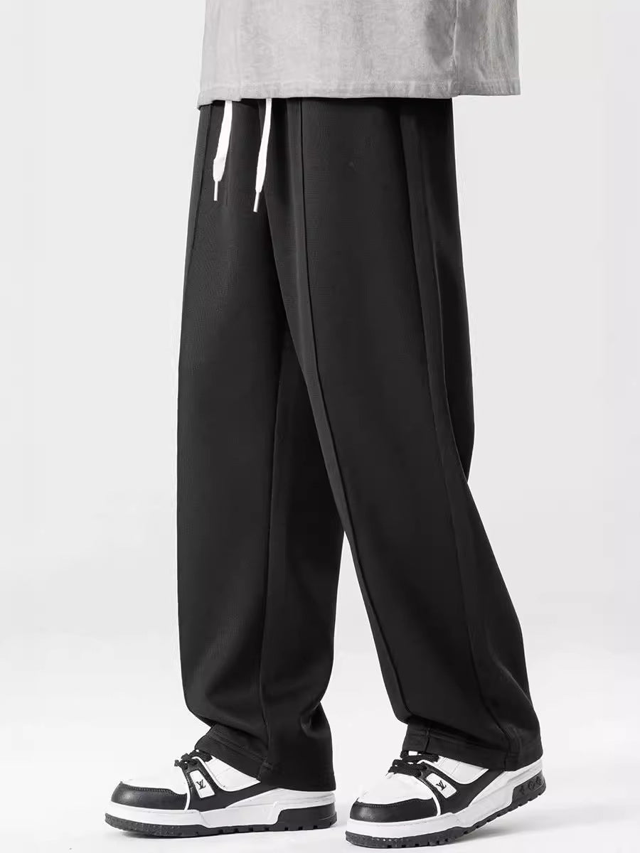 A pair of loose straight casual men's pants in black color, with a focus on the design and fit.