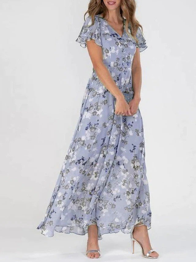 A model wearing a floral print, short sleeve, V-neck, A-line, maxi dress in blue, with additional color options shown on the side.