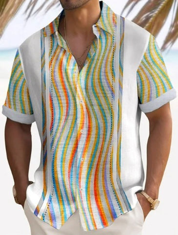 A man wearing a short-sleeved, striped beach shirt in white with multi colors